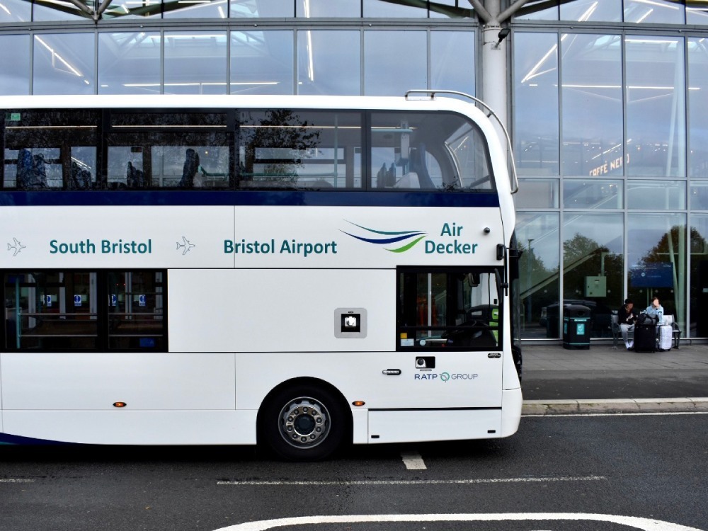 Vinyl graphics on a Bath Bus Company vehicle parked outside Bristol Airport.
