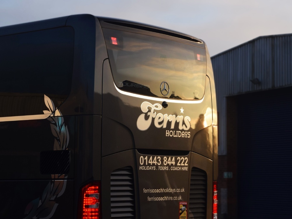 Printed vehicle graphics on a Ferris Holidays coach.