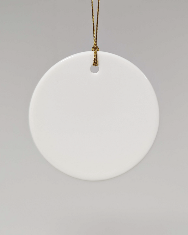Blank white ceramic ornament with gold string, ideal for custom printing, holiday crafting, or personalised eco gifts.