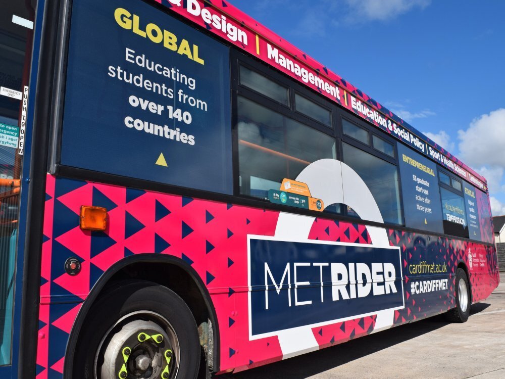Close up of colourful Cardiff Bus branded vehicle wrap on Dennis Dart.