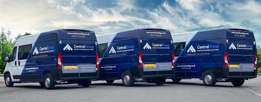 Fleet of banded leased vans with vinyl wraps for business advertising.
