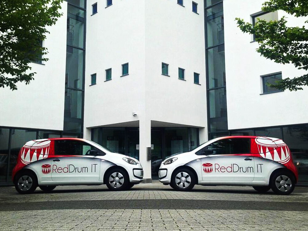 Fleet of Volkswagen Up! company cars with custom livery for RedDrum IT.