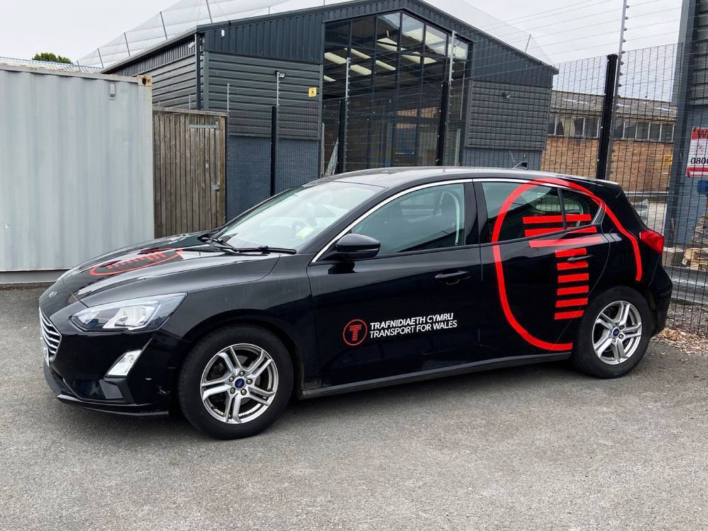 Ford Focus Transport for Wales company car with commercial branded vinyl graphics.