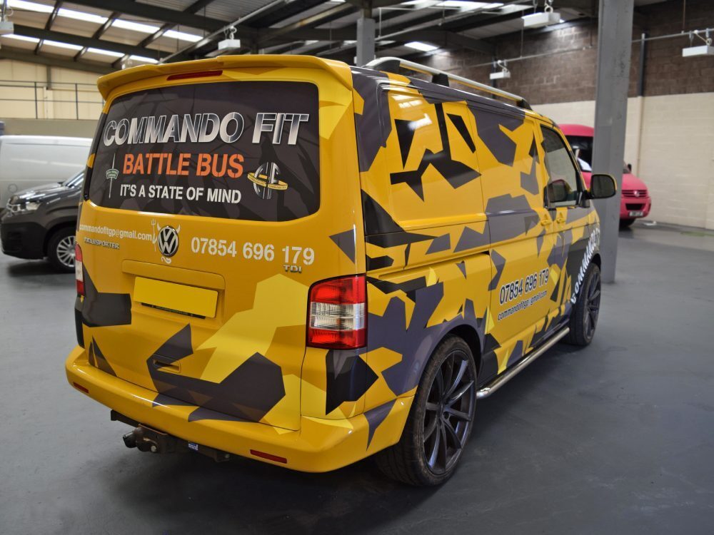 Bold yellow van wrap and window graphics on company Volkswagen Transporter.