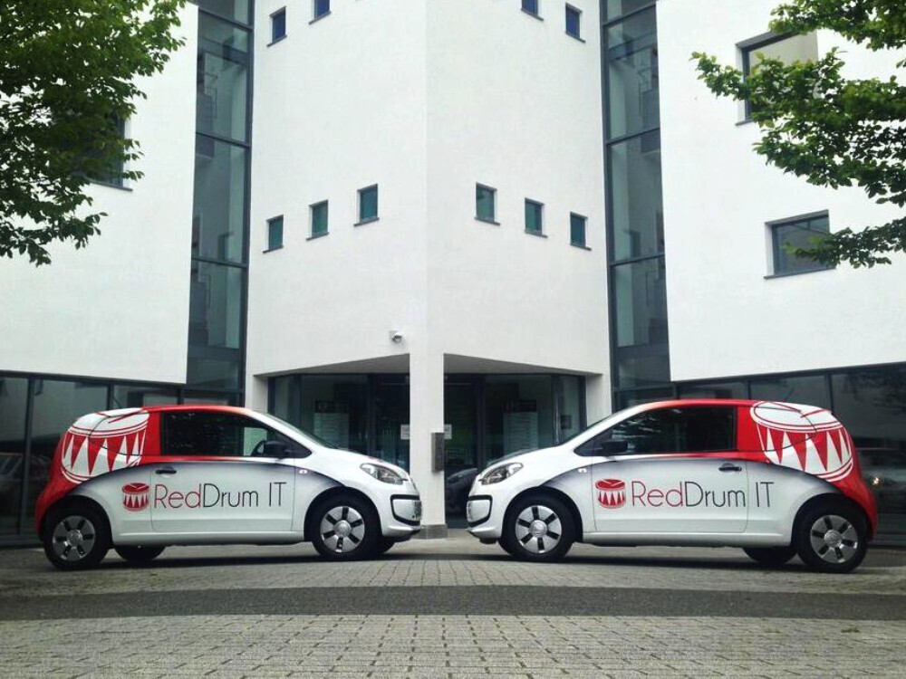 Branded vehicle wraps on car fleet for company.