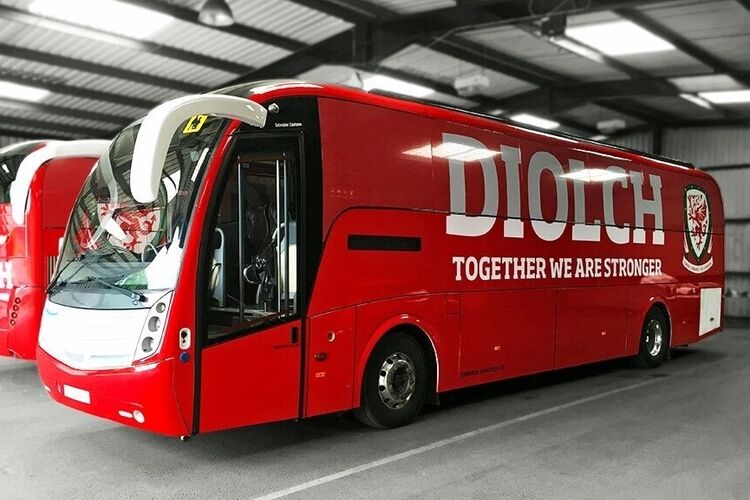 Caetano Levante coach with branded FA Wales red livery and white vinyl graphics.