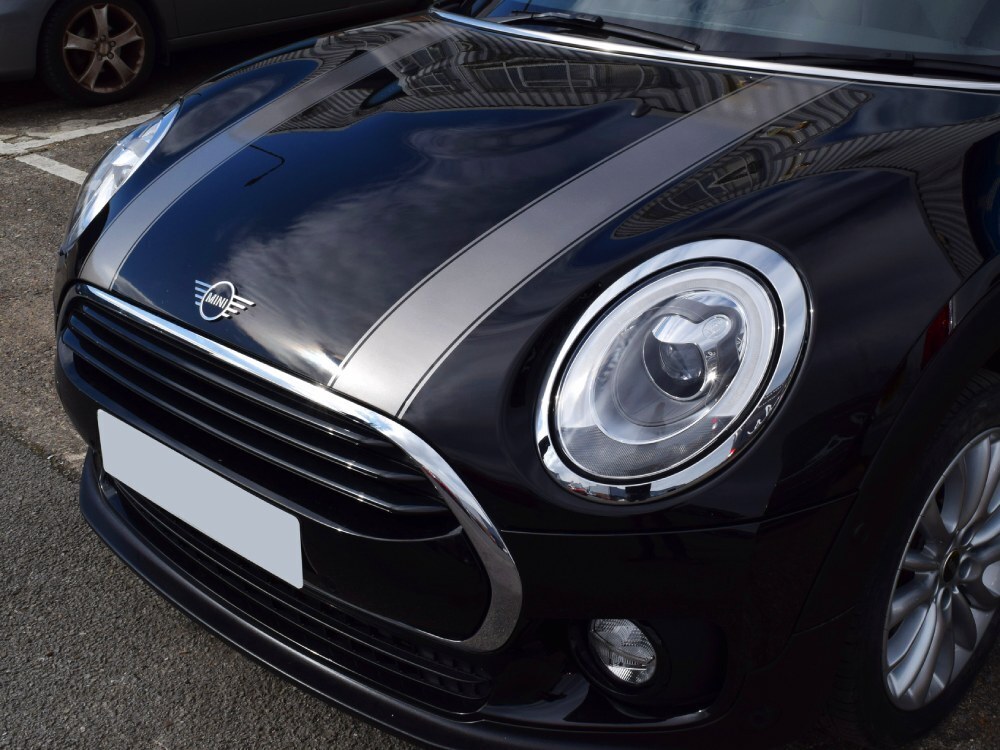 Silver sport stripe vinyl graphics on front end of black Mini Cooper