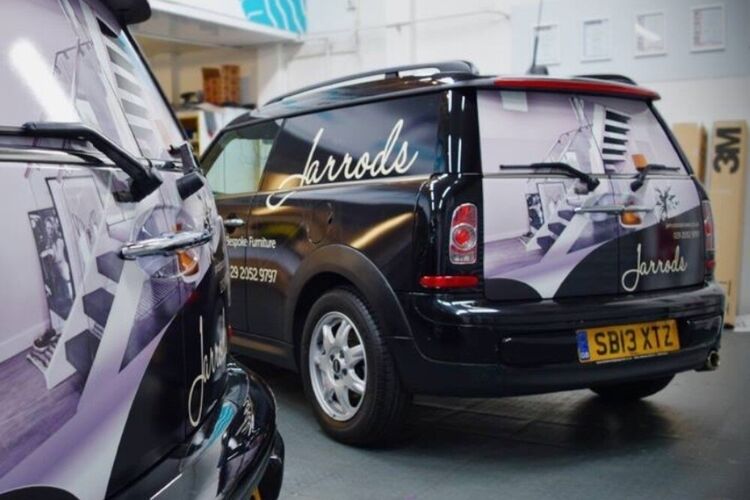 Fleet of company cars with matching wraps and branded vinyl graphics.