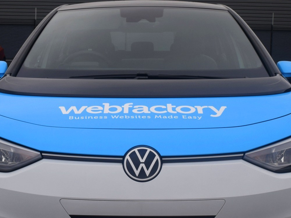 Branded vehicle wrap and graphics on bonnet of Volkswagen ID3 company car.