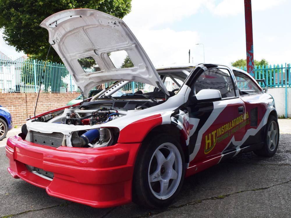 Intricate vehicle wrap and graphics on Vauxhall Astra company car.