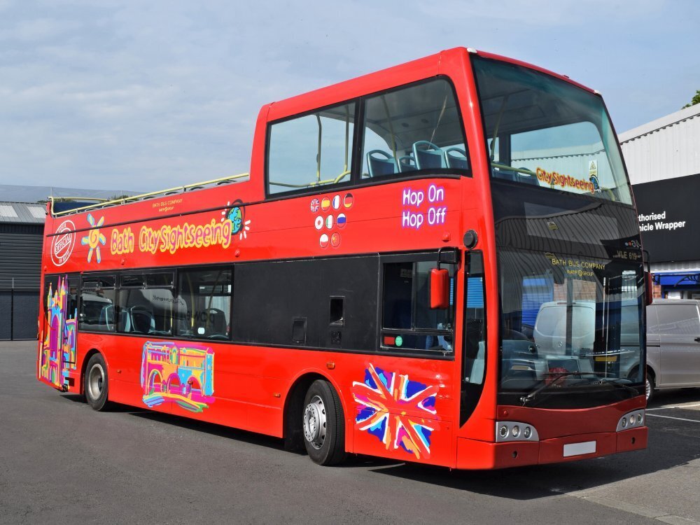 Tootbus Bath City Sightseeing branded vinyl graphics on red Optare VLE open top tour bus.