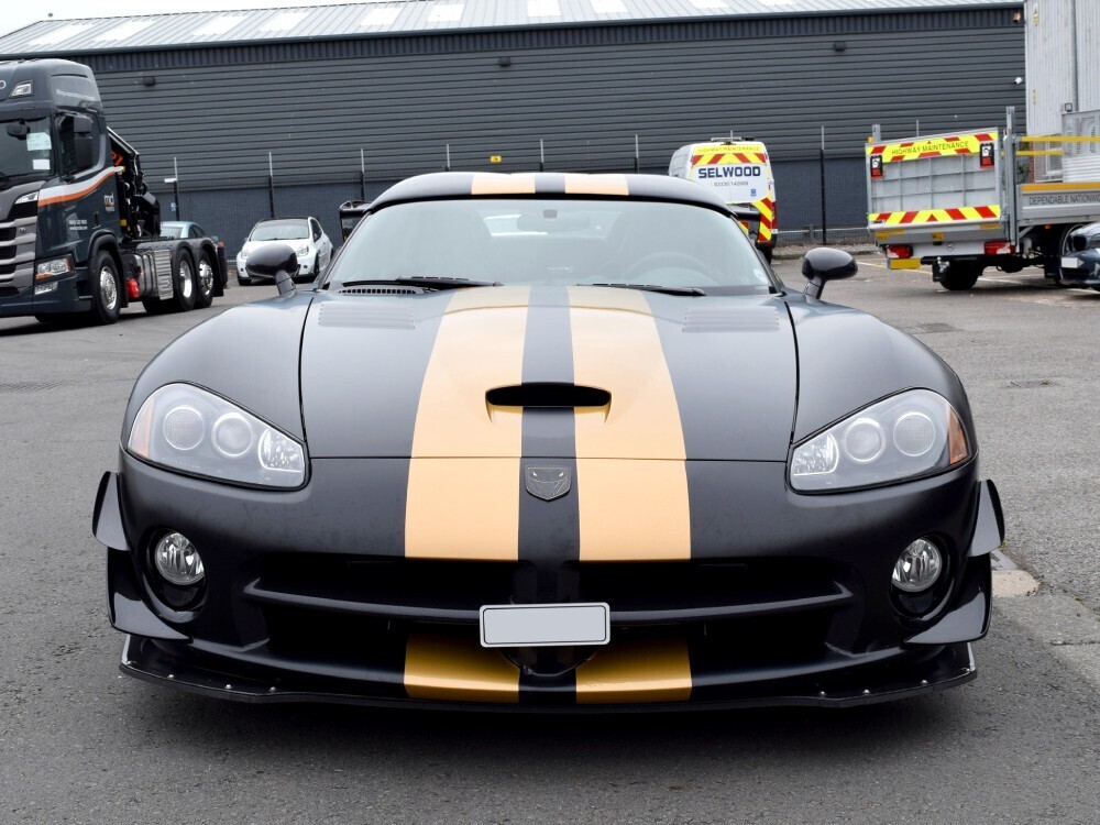 Matte black motorsport wrap with two gold stripe graphics on Dodge Viper SRT10 sports car