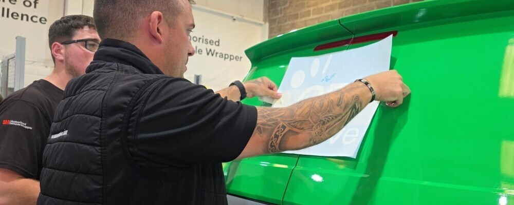A van being wrapped while meeting compliance regulations.