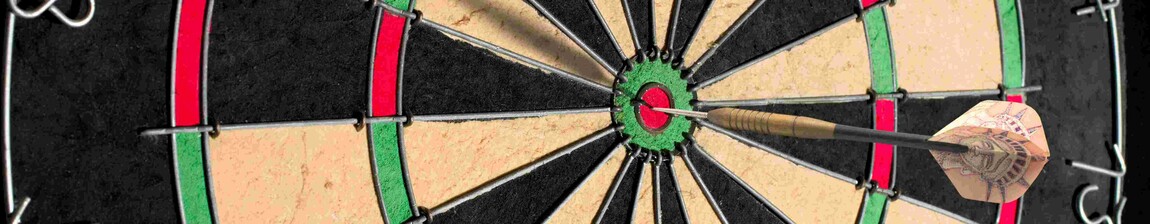 A dart in the bullseye on a dartboard.