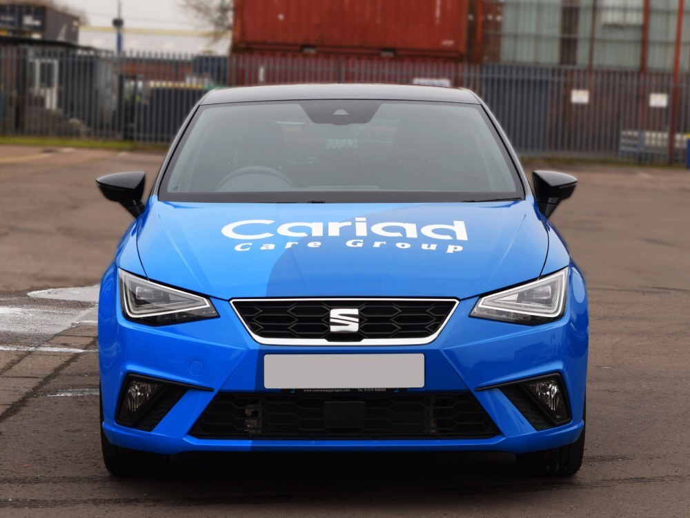 SEAT Ibiza company car with blue vehicle wrap and branded vinyl graphics.