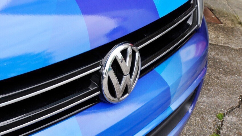 Volkswagen emblem on the front of a blue van.