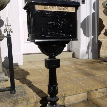 Large black metal postbox.