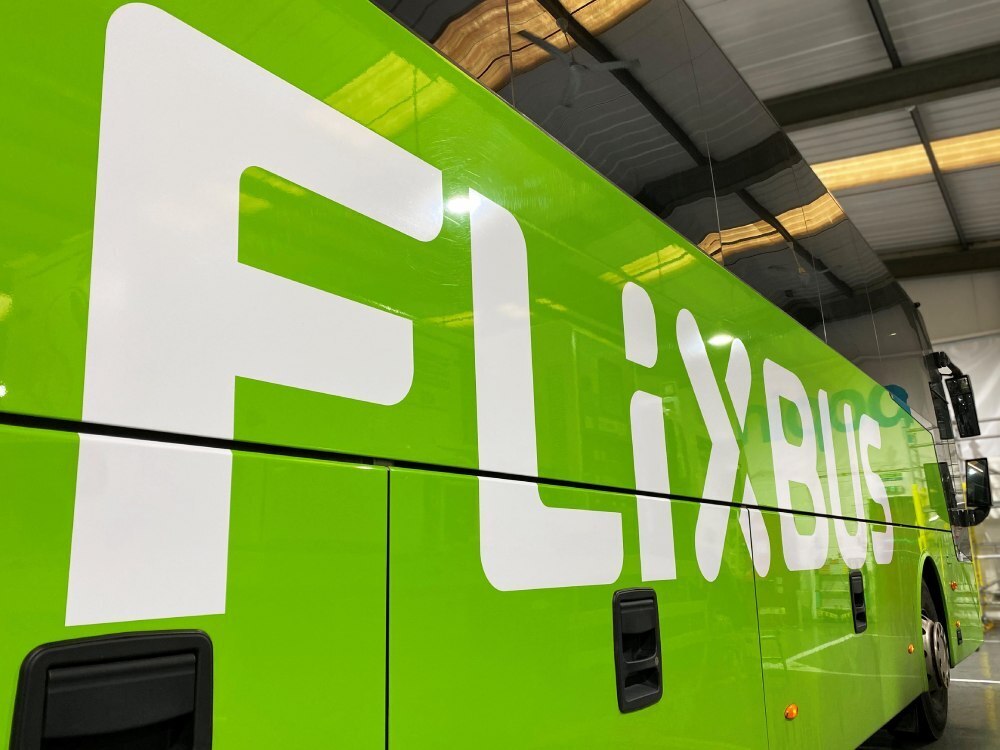 Large white vehicle vinyl graphics on green Flixbus coach.
