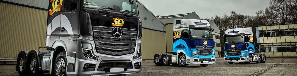 Consistent branded fleet livery on a line up of HGV trucks.