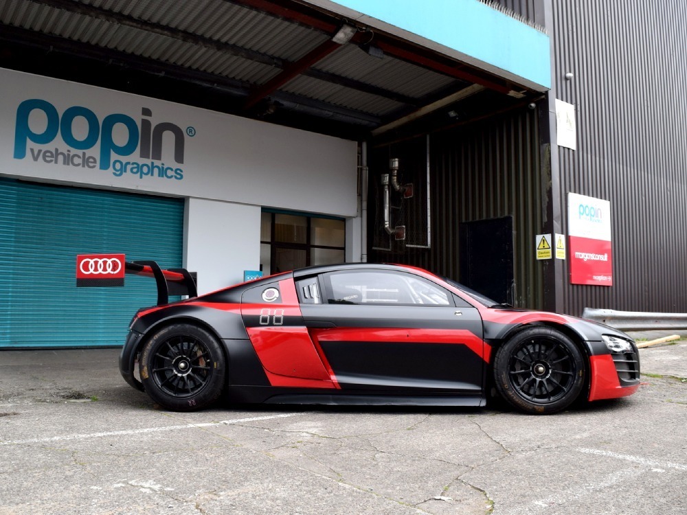 Audi R8 race car with red and black motorsport livery