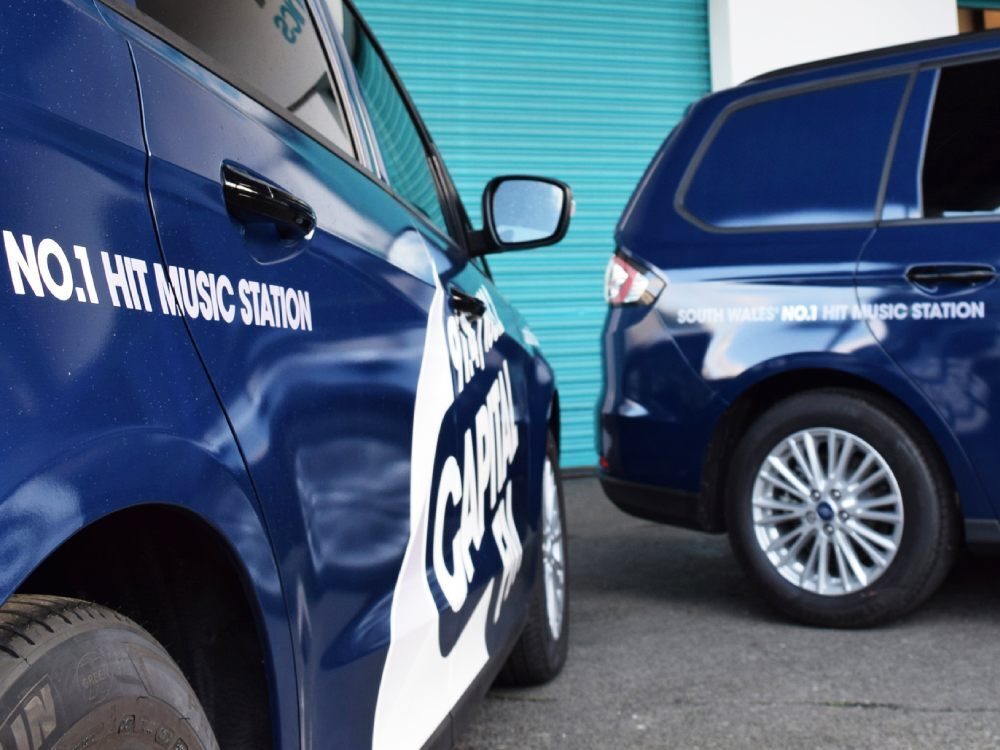 Branded vinyl graphics on fleet of company cars.
