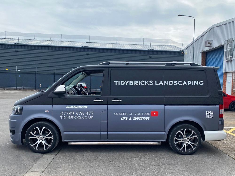 Grey van wrap and graphics on company branded Volkswagen Transporter T5.