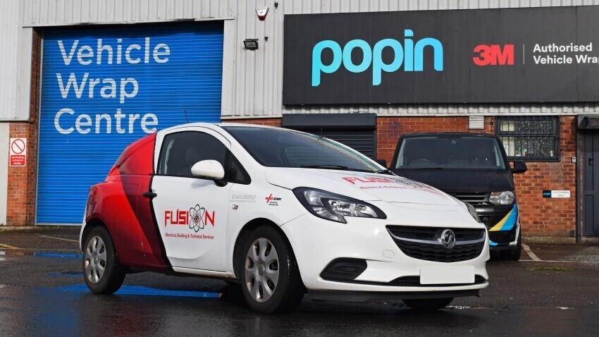 White Vauxhall Corsa company car with branded partial vehicle wrap and graphics outside Popin in Cardiff.