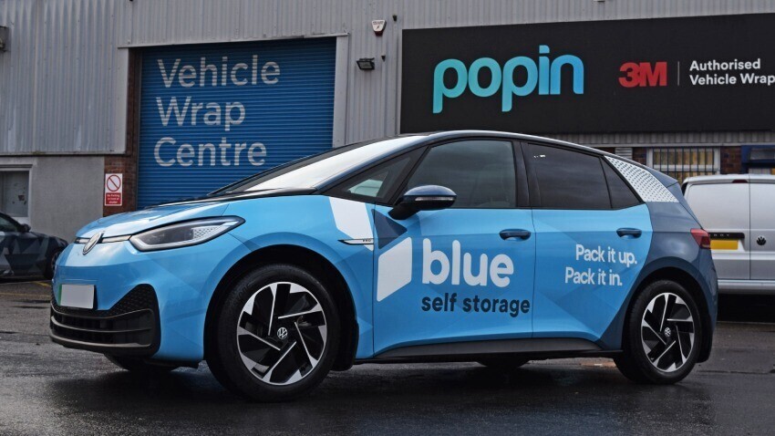 Volkswagen ID3 company car with blue branded vehicle wrap and graphics outside Popin in Cardiff.