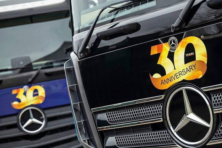 30 year anniversary promotional vinyl graphics installed on front of logistics lorries for temporary marketing campaign.