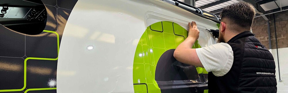Professional installation of long-life fleet vehicle graphics on a business van.