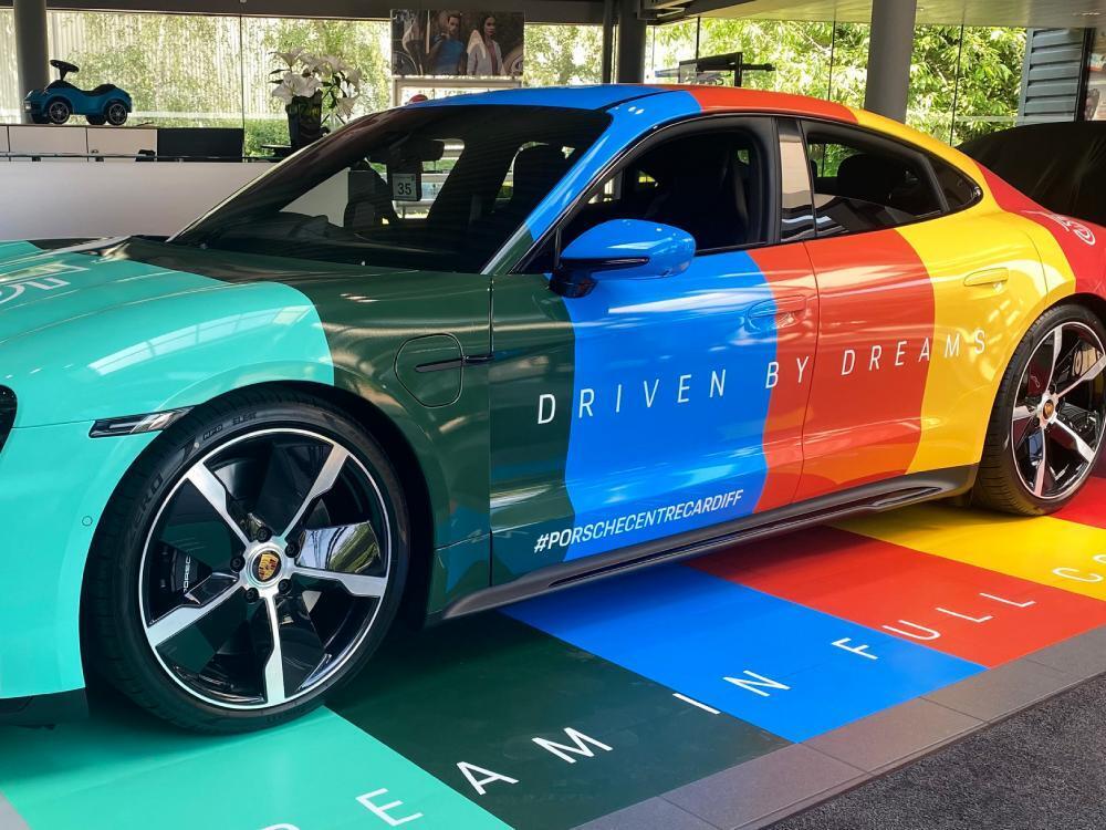 Bold colourful vehicle wrap on company Porsche Taycan Turbo.