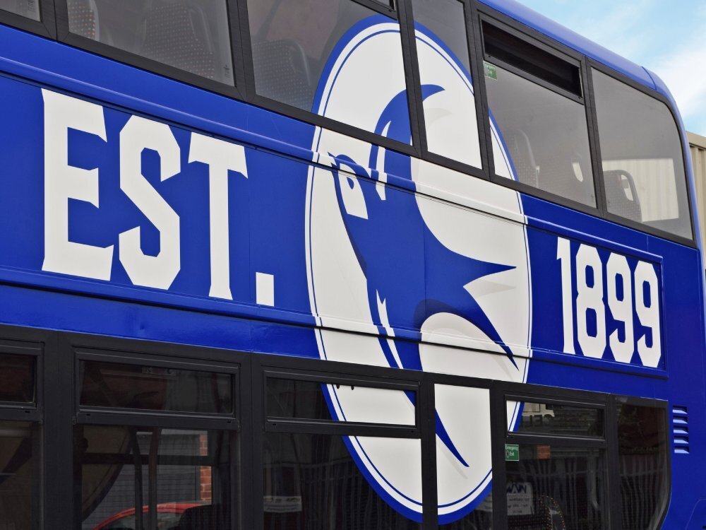 Cardiff City FC badge vinyl graphics on blue Alexander Dennis Enviro 400 bus.