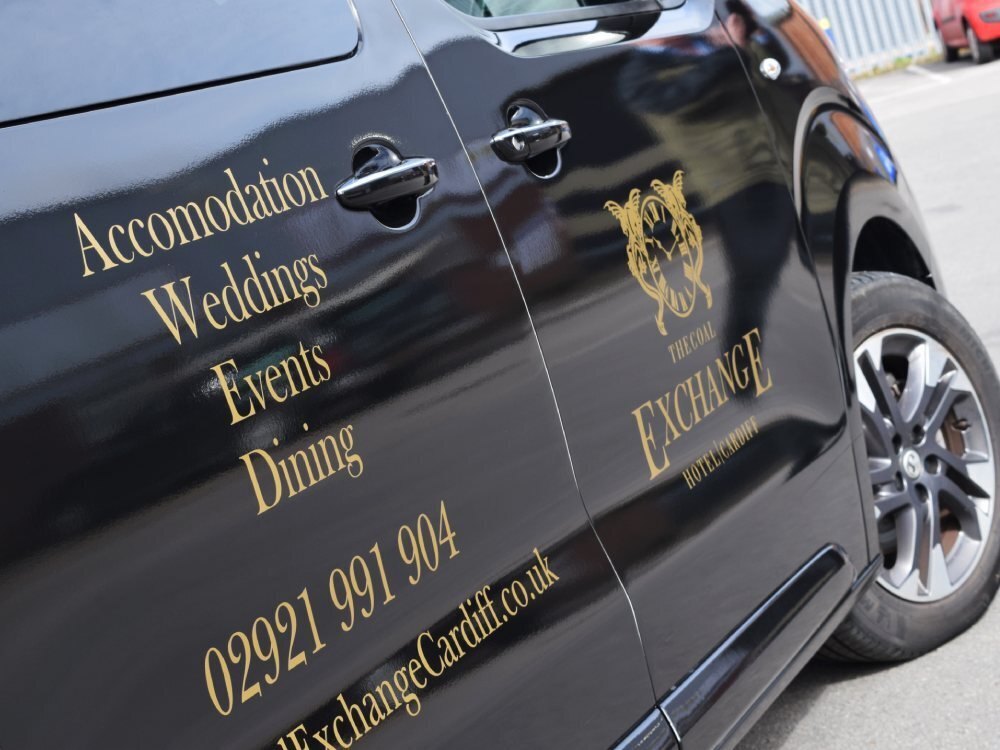 Gold company branded vehicle vinyl graphics on Vauxhall Vivaro van.