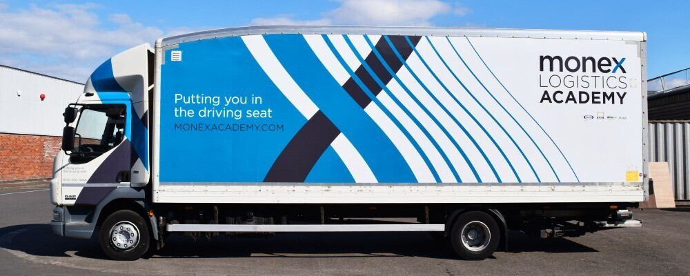 Branded large format vehicle vinyl graphic showcased on a company truck for advertising.