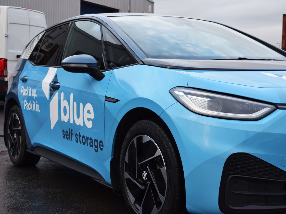 Blue vehicle livery and vinyl graphics on Volkswagen ID3 company car.