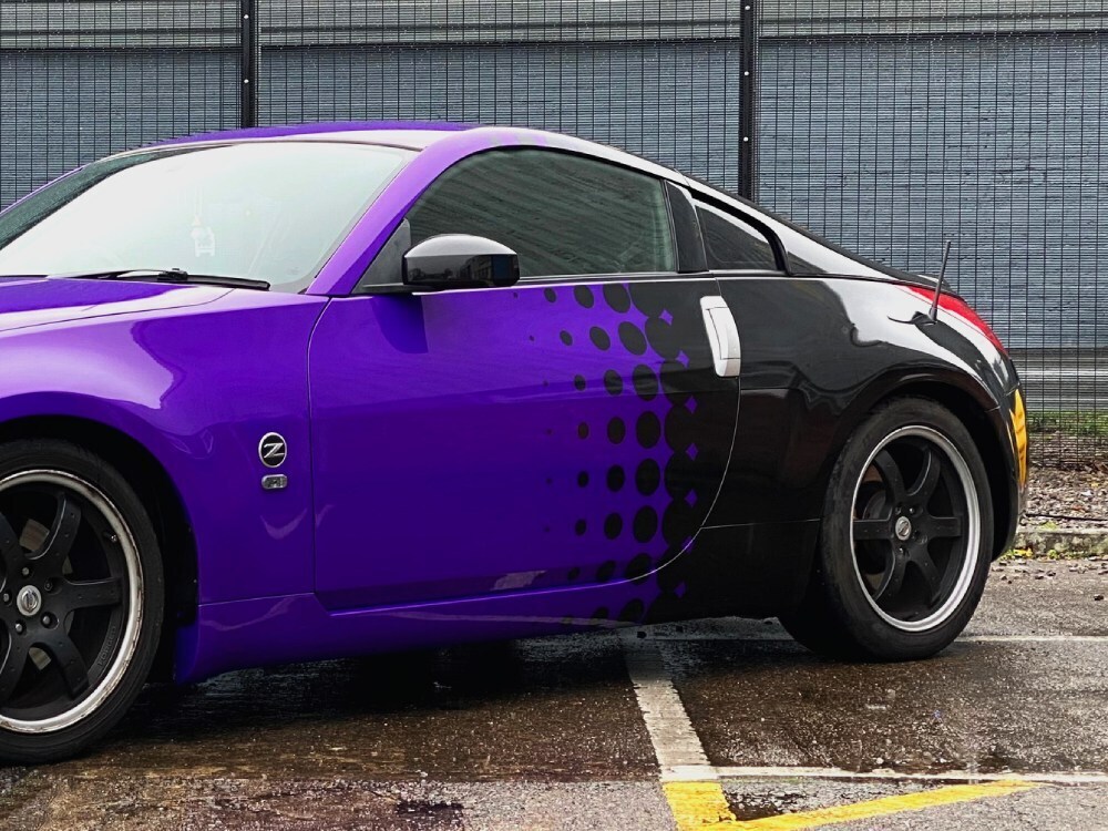 Purple motorsport livery with black graphics on rear end of a Nissan 350Z sports car