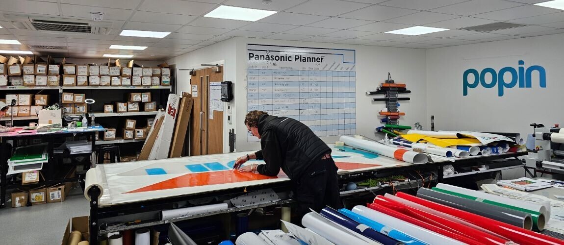 Vinyl graphic template being used in Popin production facility
