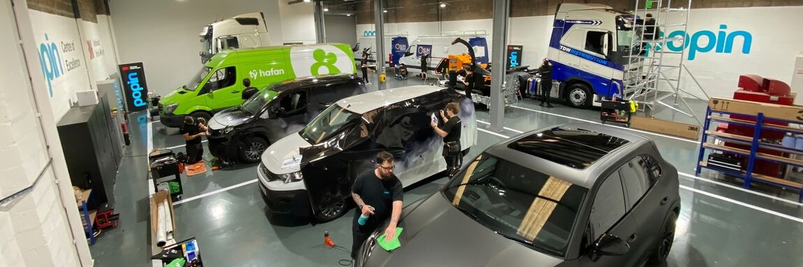 Vehicle wraps being applied using 3M materials at Popin Graphics