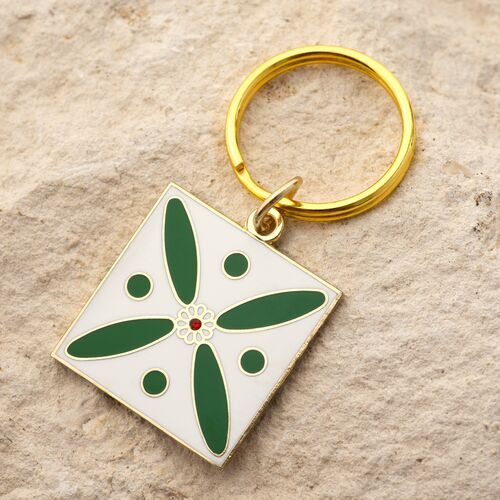 Charm. The Persian Cross. White on Green with 1 Central Red Stone.