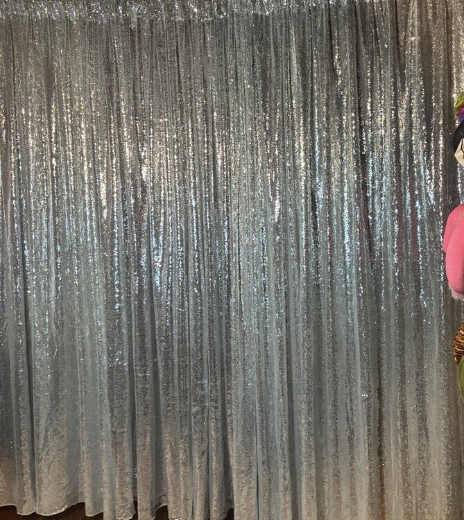 Silver sequin curtain backdrop for wedding photo booths, parties and corporate events.