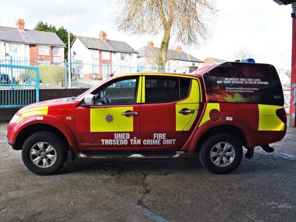 Mitsubishi L200 with red and yellow South Wales Fire livery.