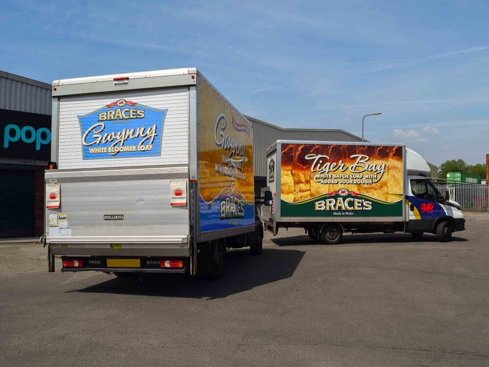 Fleet of Iveco Daily Luton Box vans with matching vehicle wraps for Brace's Bakery outside Popin in Cardiff.
