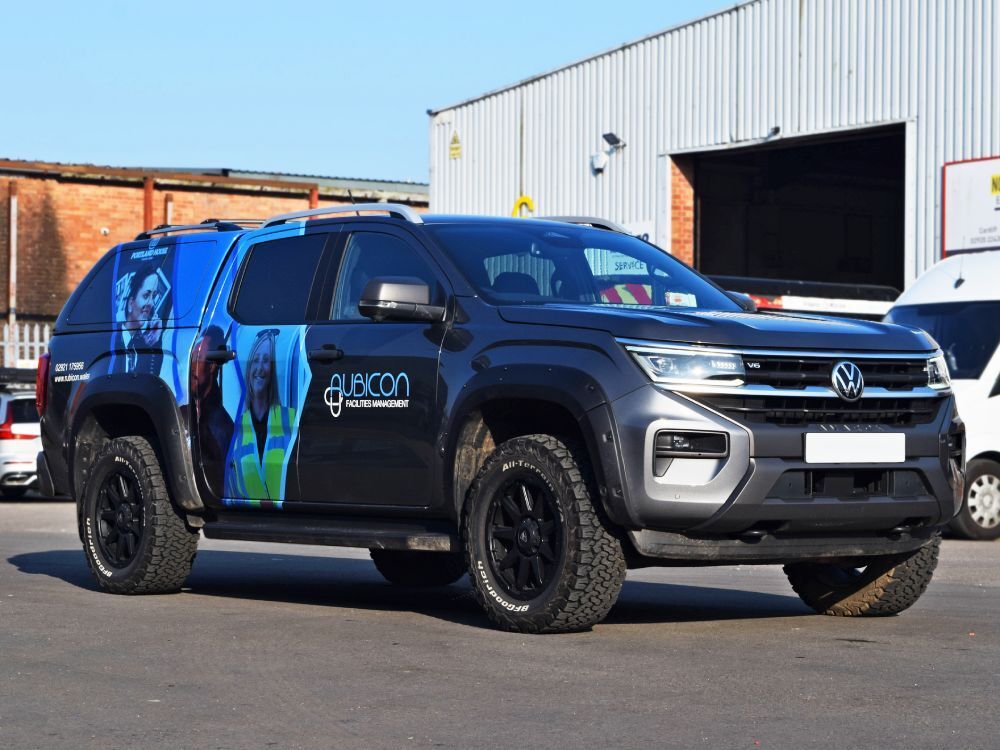 Branded partial vehicle wrap on Volkswagen Amarok company car.