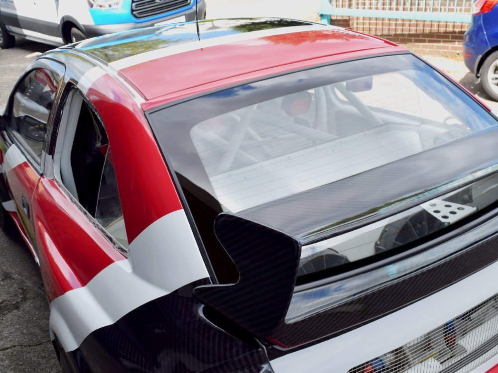 Red, black and white motorsport livery on Vauxhall Astra sports car