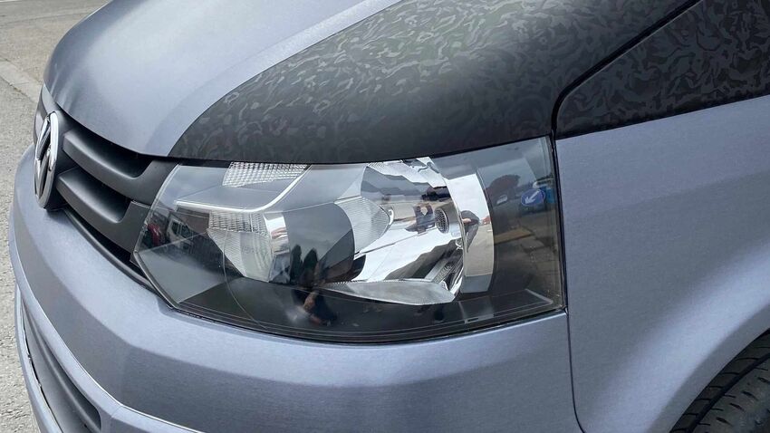 Grey matte vehicle wrap on Volkswagen Transporter company van.