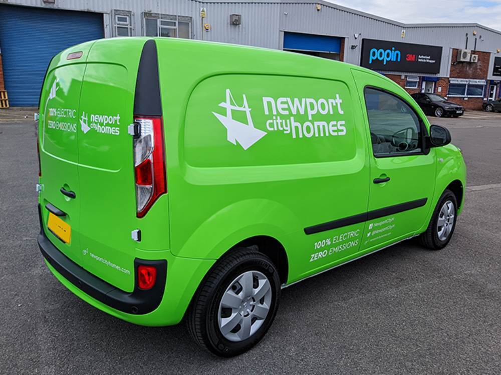 Newport City Homes bright green livery on Renault Kangoo E-Tech electric company van outside Popin in Cardiff.