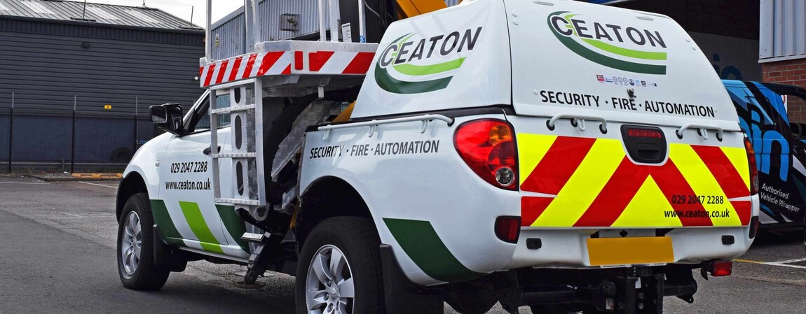 Chapter 8 reflective chevrons detail UK vehicle graphics on a white security work vehicle.