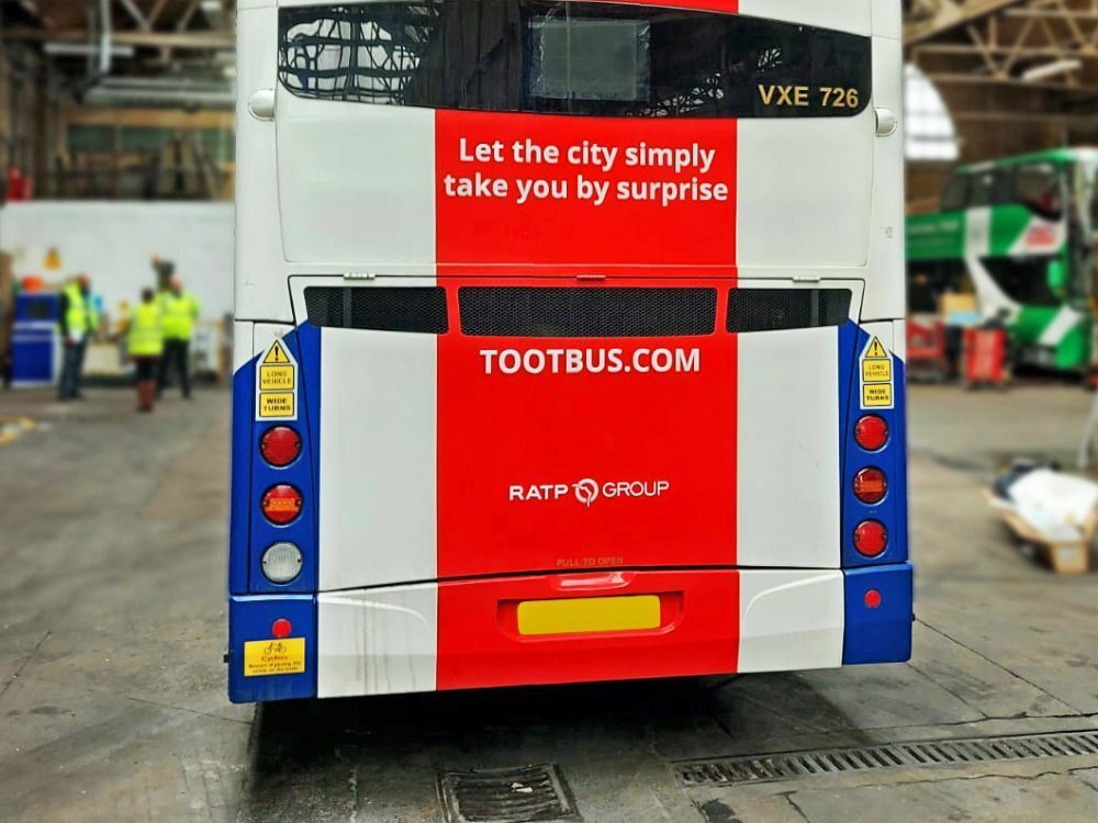Rear of Optare VXE open top tour bus with Tootbus London Union Jack vehicle wrap and vinyl graphics.