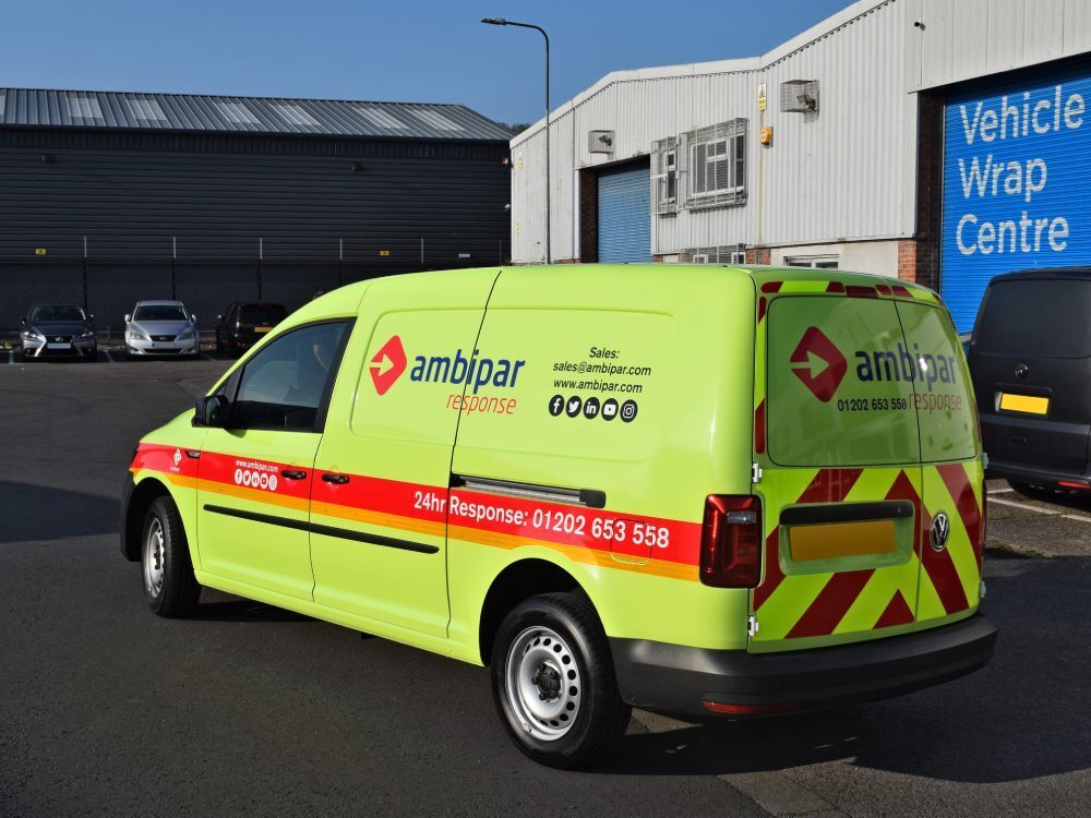Bright yellow Ambipar Response branded vehicle livery on Volkswagen Caddy Maxi outside Popin wrap centre in Cardiff.