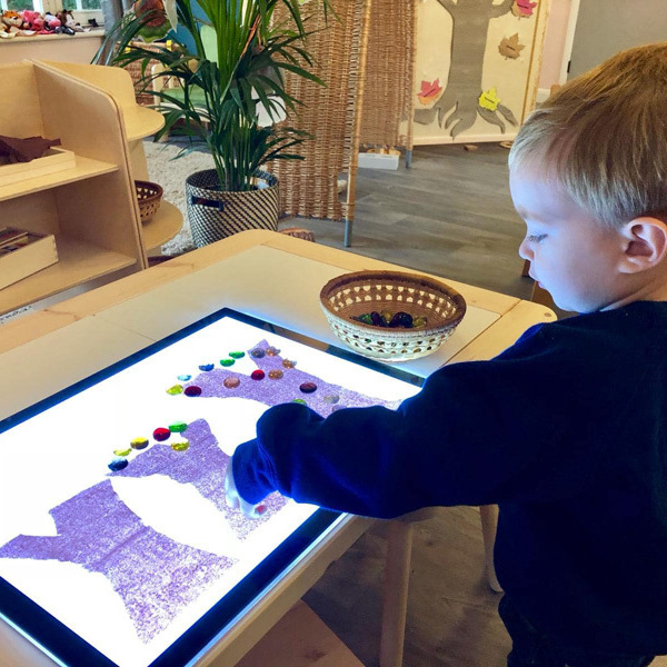 Preschool child learning with light pad